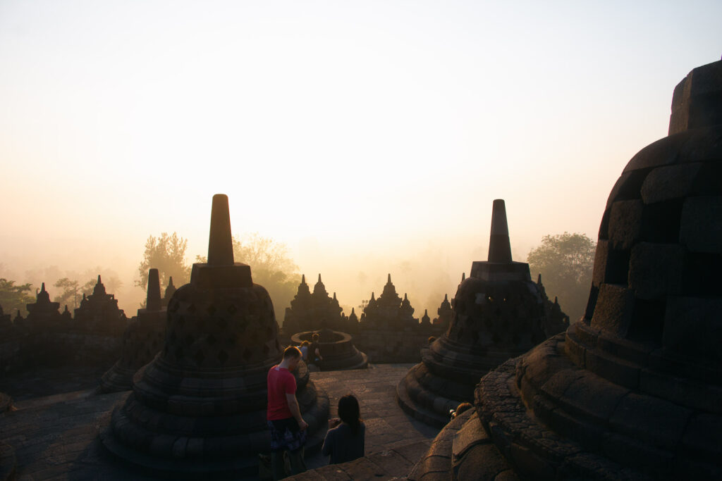 A wide shot of Borobudur temple at sunrise