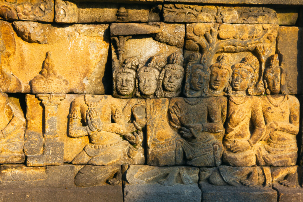 Close-up of Borobudur stone carvings with sunlight highlighting the details