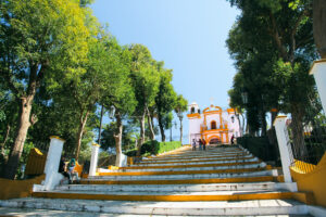 The stairs to a church surrounded by trees in San Cristobal, Mexico.