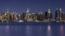 The Manhattan skyline at night as seen from across the East River
