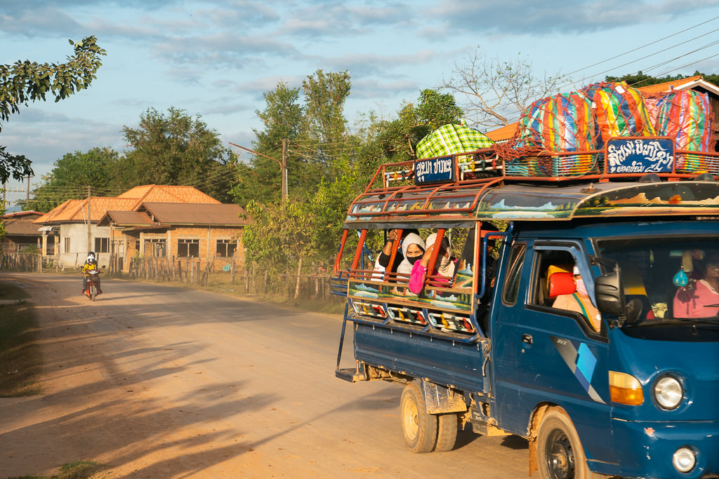 People riding a jeepney in Laos.