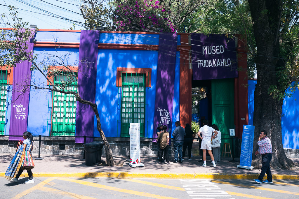 Visitors gathered outside the vividly colored entrance of the Frida Kahlo Museum in Mexico City