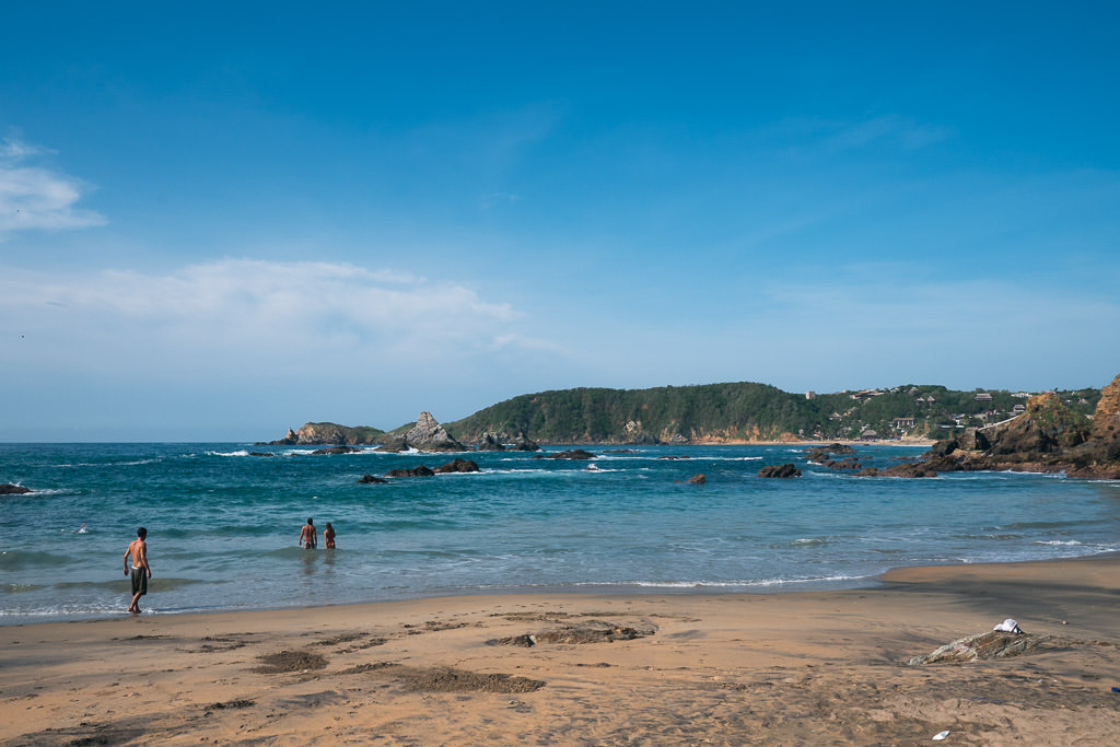 A scenic view of a beach in San Agustinillo, Oaxaca, on a clear day